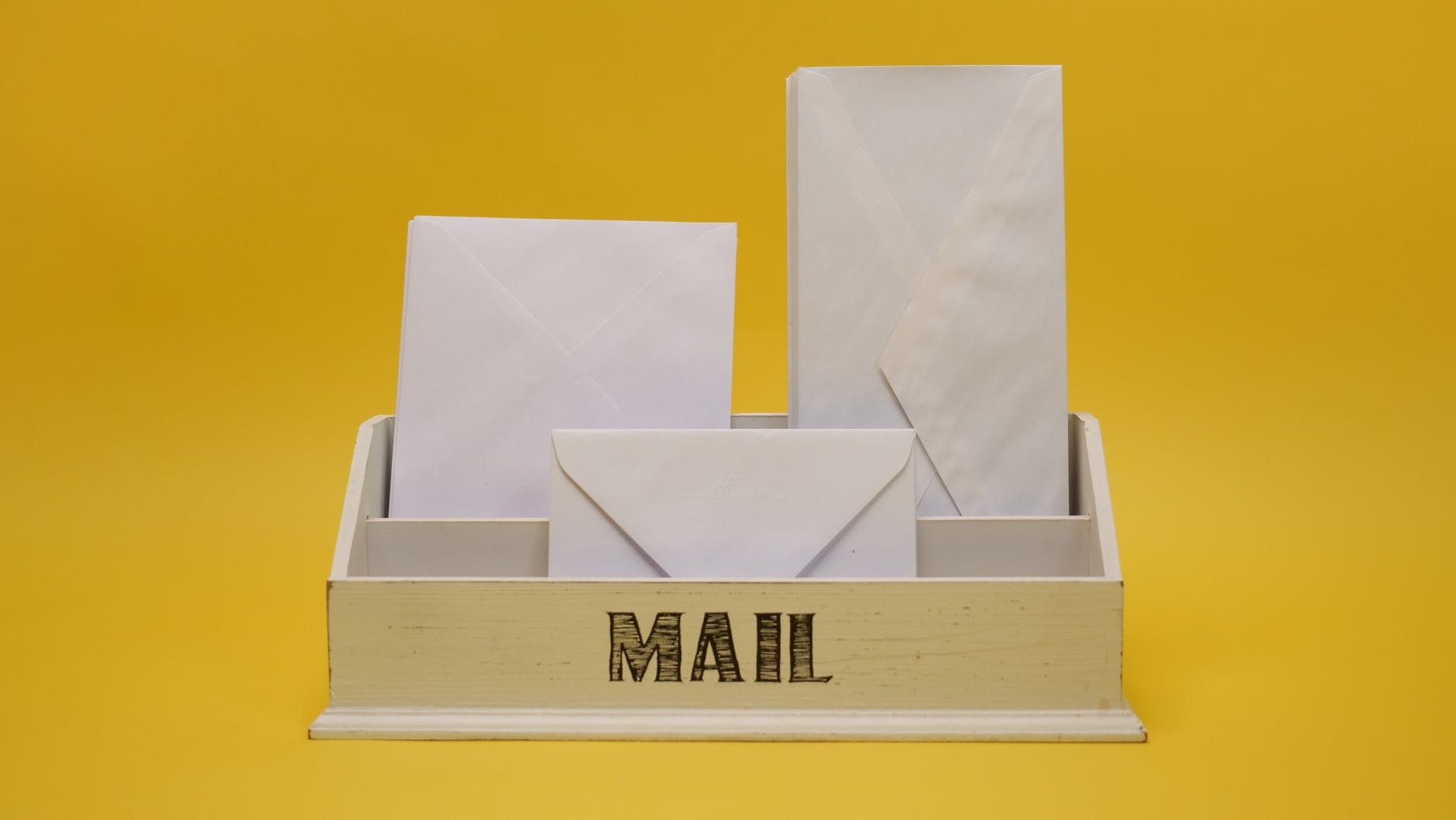 white envelopes on white wooden organizer